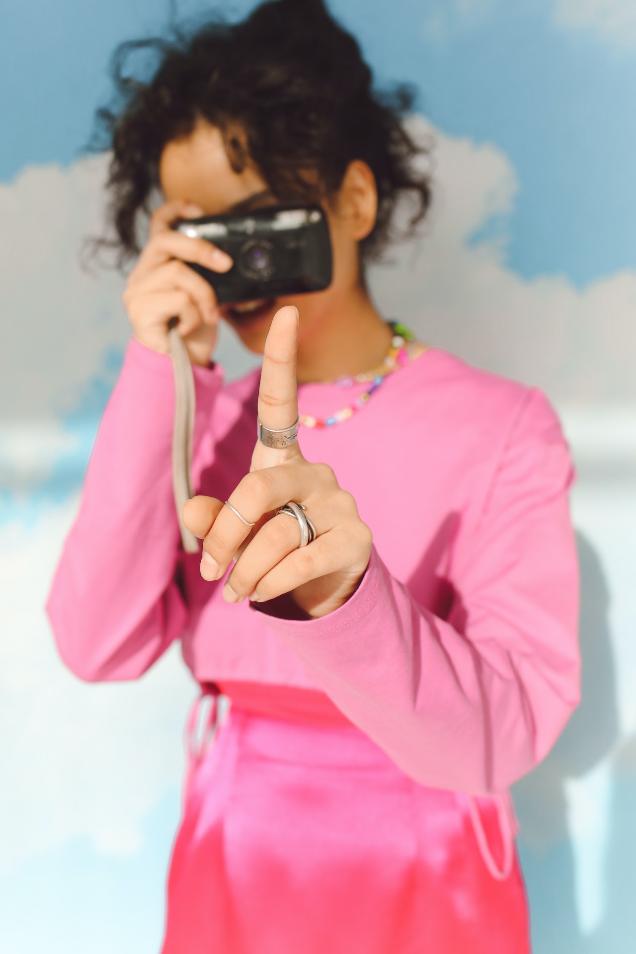 dziewczyna z aparatem w różowej bluzie